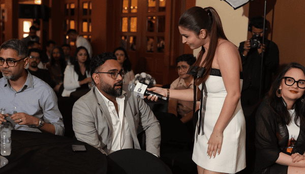 A guest being interviewed among the audience at THE H.E.L.M. 2026